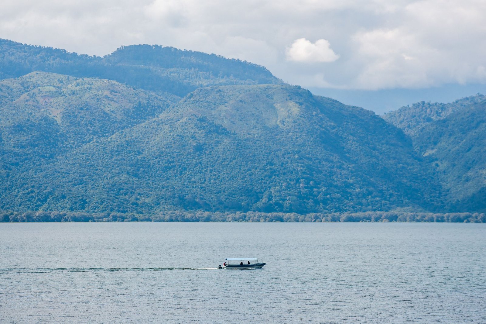 Boat on a lake surrounded by mountains in Honduras